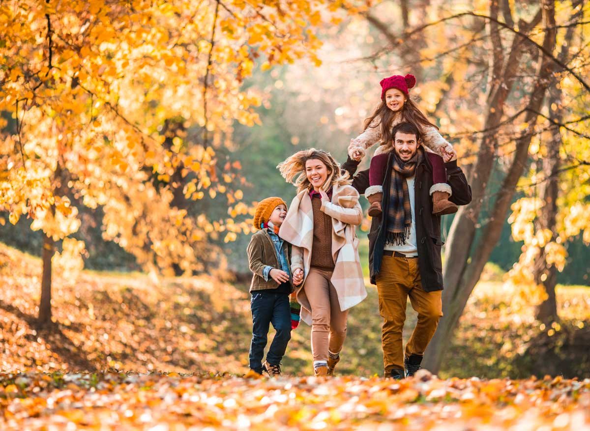 Family walking in the forest in autumn